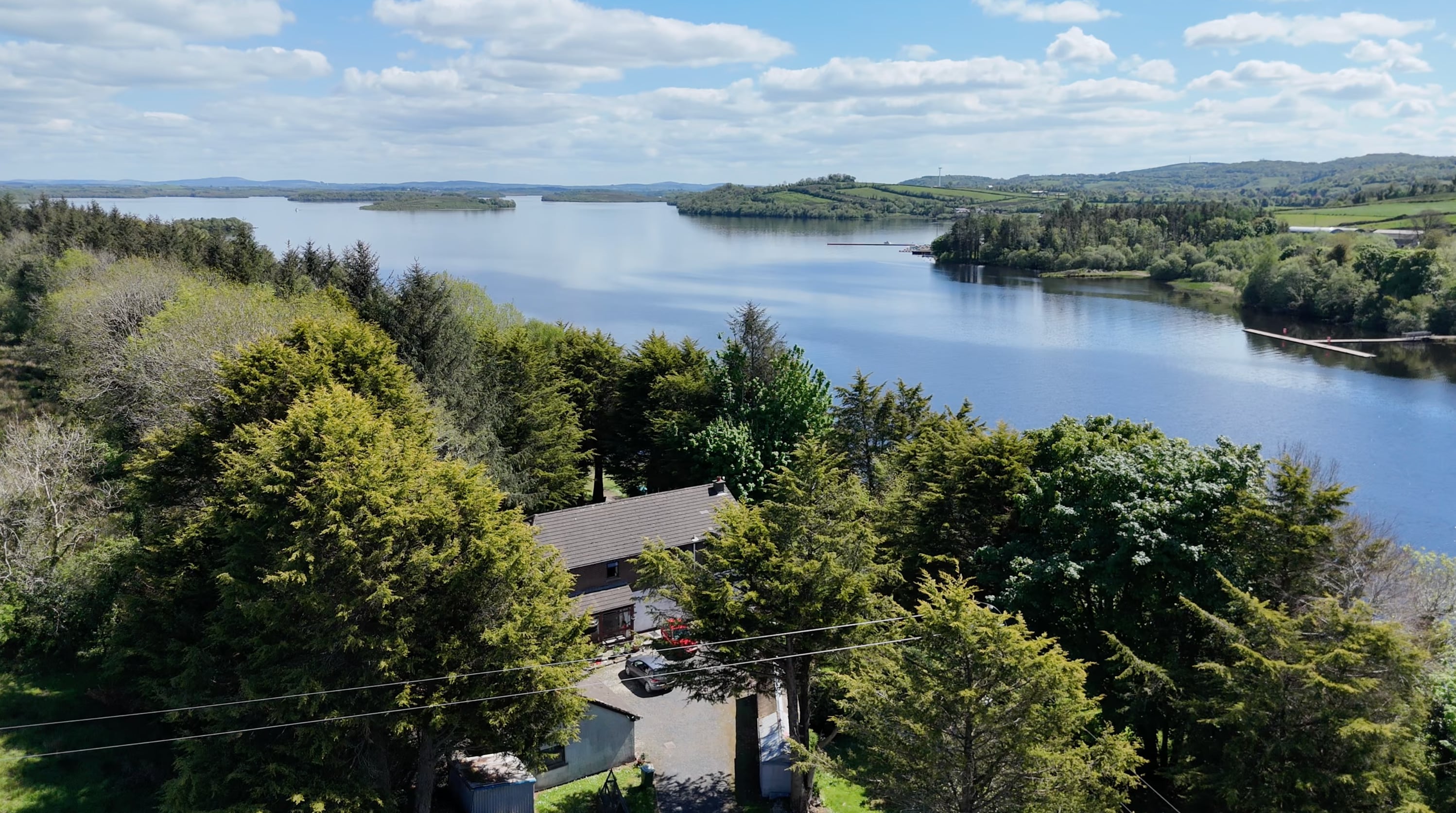 Aerial view of the residence among mature trees with Lower Lough Erne beyond